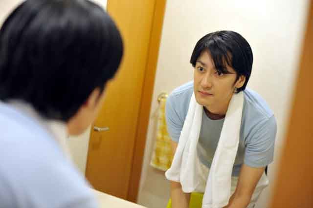鏡を見ている男性