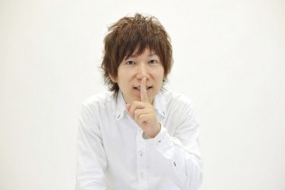 シーッと口を押さえている男性