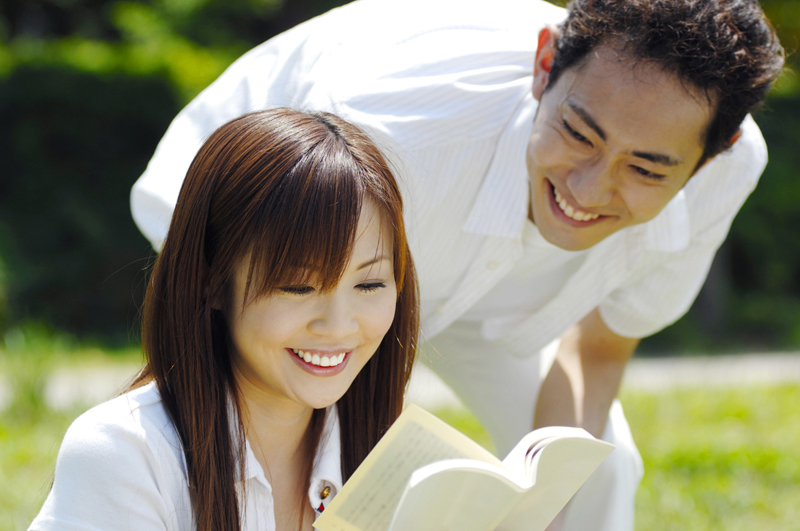 後ろから話しかける男性と女性のカップル