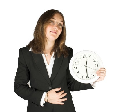 時計を持っているスーツ女性